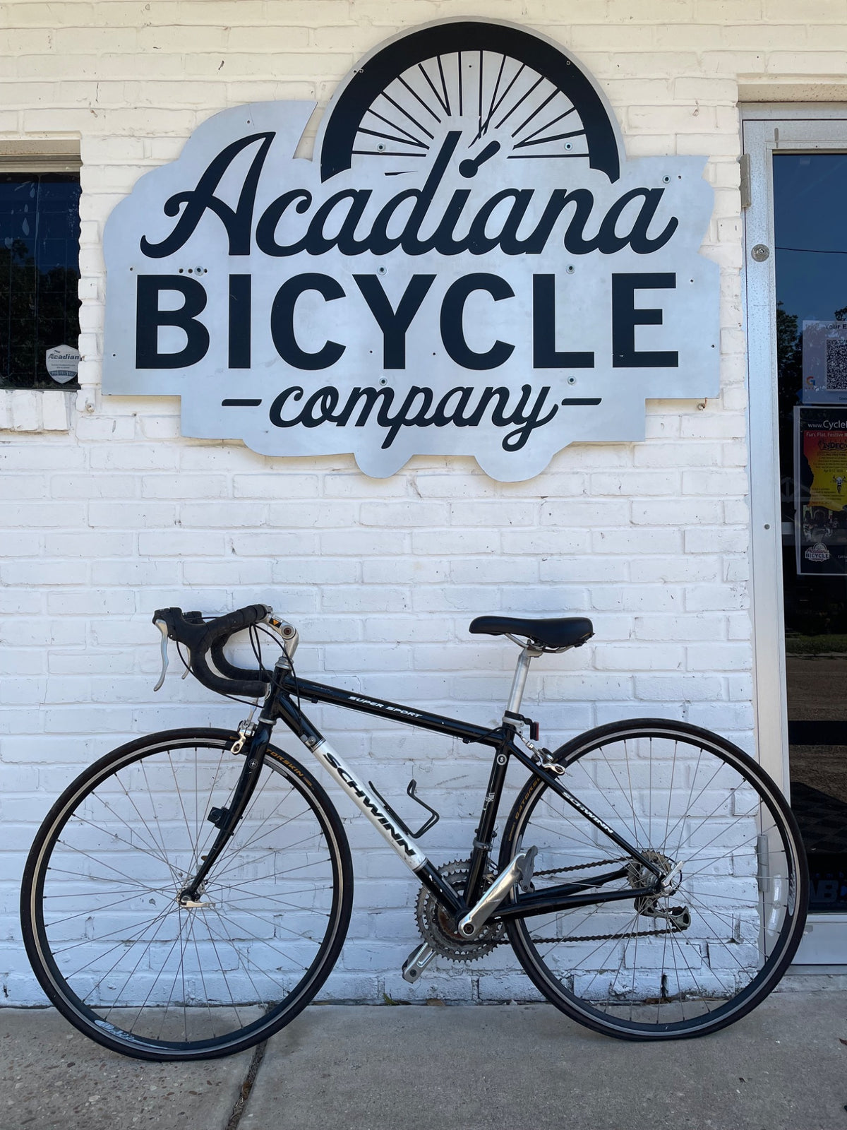 Used black Schwinn Super Sport road bicycle photographed outside Acadiana Bicycle Company