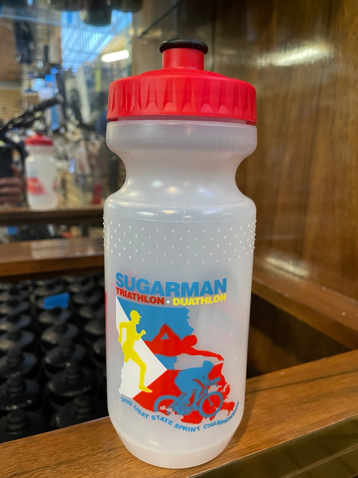 Sugarman triathlon graphic on clear water bottle