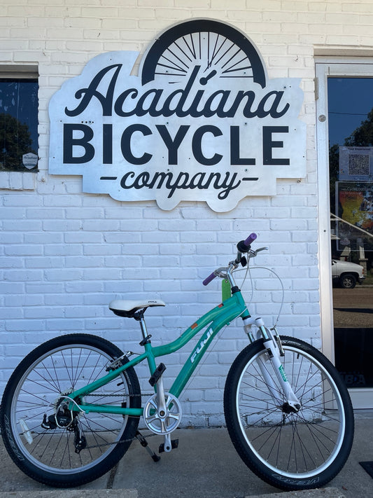Used green Fuji Dynamite 24-inch kids bicycle at Acadiana Bicycle Company