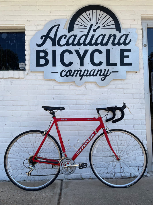 Used red Cannondale R200 road bike outside Acadiana Bicycle Company