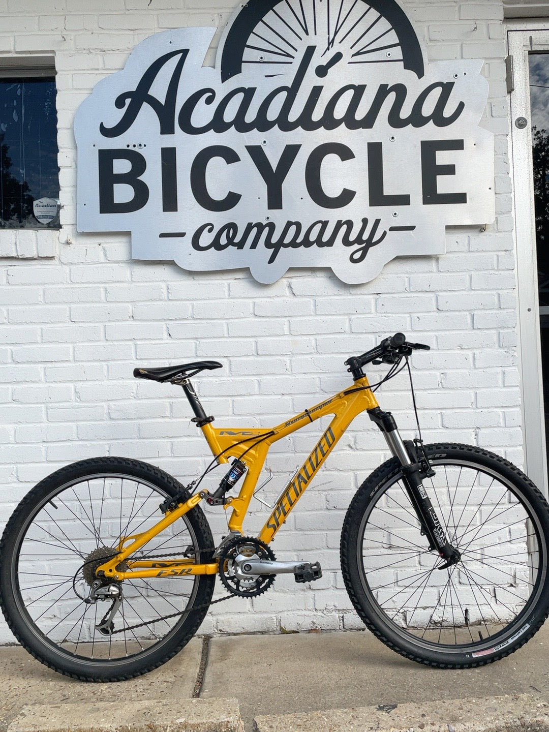 Yellow Specialized FSR XC full suspension mountain bike photographed at Acadiana Bicycle Company